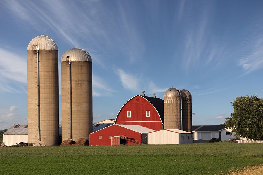 Specialized Business Insurance - View of a Traditional Farm Building with Two Grain Silos in a Rural Setting